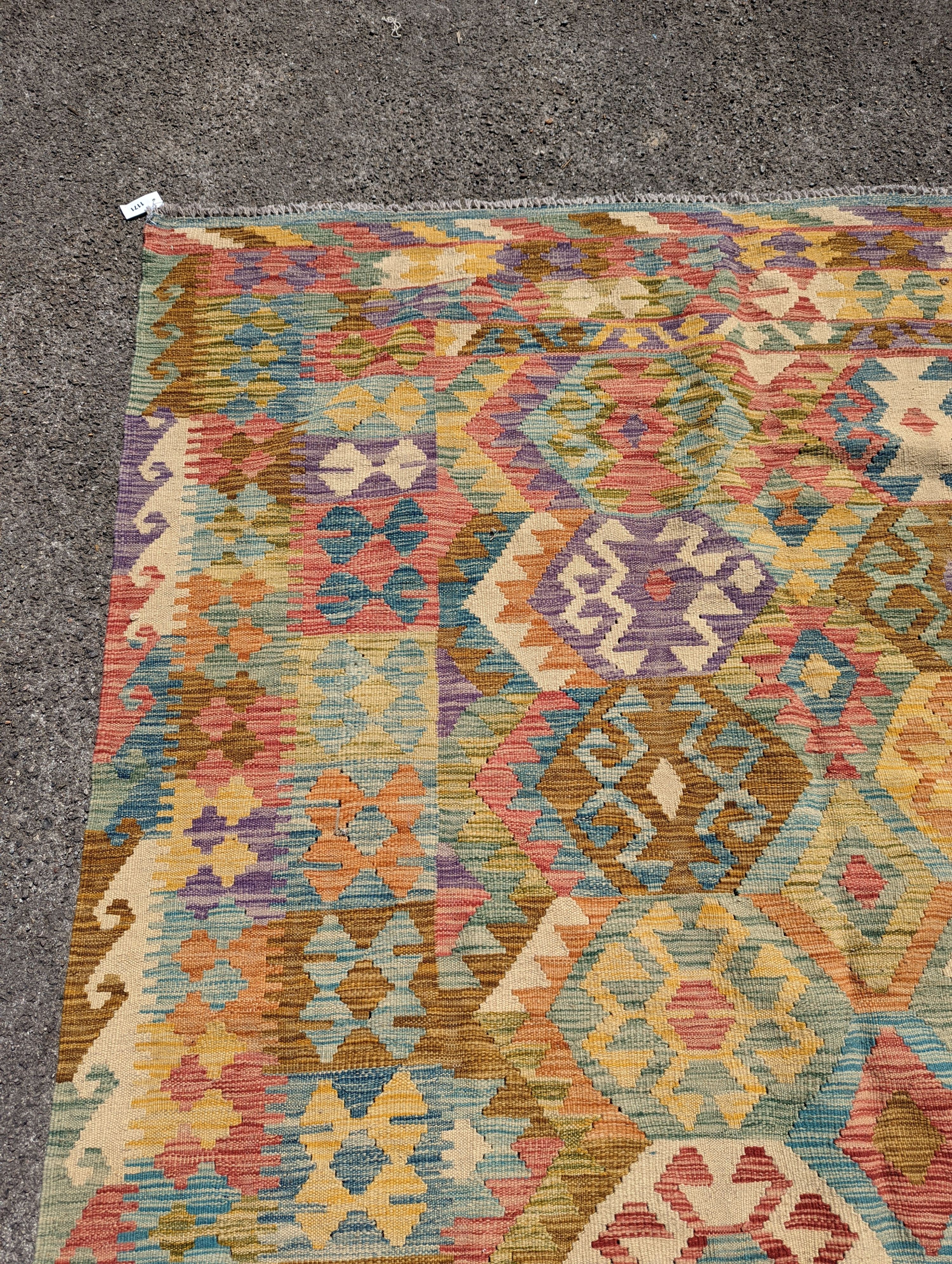 An Anatolian design polychrome geometric flatweave Kilim carpet 270 x 200cm